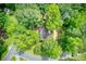 Lush aerial view showcasing the home nestled amongst mature trees in a serene neighborhood setting at 1220 Wade Green Nw Cir, Acworth, GA 30102
