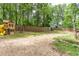 Large backyard with wooden playground equipment, swing set, and a sturdy wooden fence for privacy and safety at 1220 Wade Green Nw Cir, Acworth, GA 30102