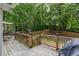 Large backyard with a wooden deck, play set, privacy fence, and lush trees at 1220 Wade Green Nw Cir, Acworth, GA 30102