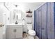 Clean bathroom with white vanity, framed mirror, toilet, and bathtub/shower with blue curtain at 1220 Wade Green Nw Cir, Acworth, GA 30102