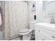 Charming bathroom featuring a patterned shower curtain, built-in shelving, and a modern white vanity at 1220 Wade Green Nw Cir, Acworth, GA 30102