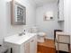 Cozy bathroom with a white vanity, medicine cabinet and wood-look floor at 1220 Wade Green Nw Cir, Acworth, GA 30102