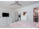 Cozy bedroom with a ceiling fan, dresser, and organized closet space, perfect for relaxation and storage at 1220 Wade Green Nw Cir, Acworth, GA 30102