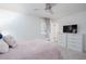 Bright bedroom featuring a soft pink quilted bedspread, dresser, and large windows offering natural light at 1220 Wade Green Nw Cir, Acworth, GA 30102