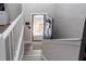 Bright entryway featuring a welcoming front door, gray wood flooring, and white railings at 1220 Wade Green Nw Cir, Acworth, GA 30102