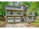 Charming two-story home with gray siding, a two-car garage, and a welcoming front porch at 1220 Wade Green Nw Cir, Acworth, GA 30102