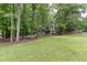Home with a well-manicured lawn and mature trees, providing a peaceful and private environment at 1220 Wade Green Nw Cir, Acworth, GA 30102
