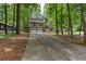View of the home featuring a long driveway, a two-car garage, and a well-maintained front yard at 1220 Wade Green Nw Cir, Acworth, GA 30102