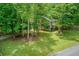 Home nestled among mature trees and a large lawn, offering a private and scenic setting at 1220 Wade Green Nw Cir, Acworth, GA 30102