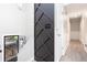 Bright hallway featuring a decorative accent wall, wainscoting, and hardwood floors creating a welcoming home at 1220 Wade Green Nw Cir, Acworth, GA 30102