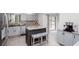 Bright kitchen with an island including bar seating and a stainless steel dishwasher at 1220 Wade Green Nw Cir, Acworth, GA 30102