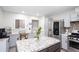Bright kitchen with an island including an eat in bar area with seating, stainless appliances, and granite counters at 1220 Wade Green Nw Cir, Acworth, GA 30102