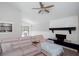 Open living room space with a fireplace, wood flooring, a ceiling fan, and comfortable seating at 1220 Wade Green Nw Cir, Acworth, GA 30102