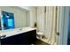 Bright bathroom with a modern vanity, framed mirror, and stylish shower curtain with yellow accents at 1606 Larkspur Trl, Conyers, GA 30012