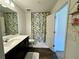 Bathroom featuring floral shower curtain, vanity with sink, and a toilet for convenience at 1606 Larkspur Trl, Conyers, GA 30012
