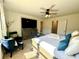 Spacious bedroom featuring a TV, ceiling fan and adjacent bathroom, a great space to relax at 1606 Larkspur Trl, Conyers, GA 30012