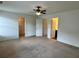 Spacious bedroom features a ceiling fan and ample closet space for comfortable living at 1606 Larkspur Trl, Conyers, GA 30012