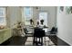 Well-lit dining area with a modern round table, sleek black chairs, and decorative floral curtains at 1606 Larkspur Trl, Conyers, GA 30012