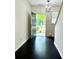 Foyer features wood floors leading to an open front door and stairwell, inviting natural light at 1606 Larkspur Trl, Conyers, GA 30012