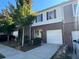 Charming townhome featuring a brick facade, attached garage, and well-maintained front yard landscaping at 1606 Larkspur Trl, Conyers, GA 30012