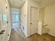 Hallway with carpet and white doors that leads to other rooms in the home at 1606 Larkspur Trl, Conyers, GA 30012
