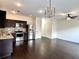 Bright kitchen with dark wood cabinets, stainless steel appliances, and hardwood floors in an open layout at 1606 Larkspur Trl, Conyers, GA 30012