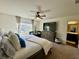 Beautiful main bedroom with large window, ceiling fan, and en suite bathroom at 1606 Larkspur Trl, Conyers, GA 30012
