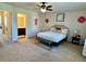 Bedroom featuring a ceiling fan, decorative wall art, and a cozy bed with a cushioned bench at 1606 Larkspur Trl, Conyers, GA 30012