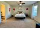 Main bedroom with a ceiling fan, comfortable bed, bedside table, and bright natural light at 1606 Larkspur Trl, Conyers, GA 30012