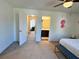 Main bedroom featuring a doorway to an en-suite bathroom and a hallway leading to other rooms at 1606 Larkspur Trl, Conyers, GA 30012