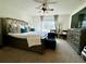 Spacious main bedroom with a plush bed, ceiling fan, and a window, providing a relaxing atmosphere at 1606 Larkspur Trl, Conyers, GA 30012