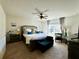 Comfortable main bedroom with a plush bed, ceiling fan, and a window, offering a peaceful retreat at 1606 Larkspur Trl, Conyers, GA 30012