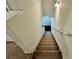 Carpeted staircase with a white handrail leading to the next level of the home at 1606 Larkspur Trl, Conyers, GA 30012