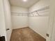 Walk-in closet features wire shelving to organize clothing, shoes, and accessories at 1606 Larkspur Trl, Conyers, GA 30012