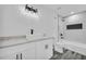 Modern bathroom with double sink vanity, stylish fixtures, and tiled shower at 5200 Beechwood Forest Ct, Lithonia, GA 30038