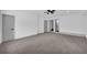 Large bedroom with neutral carpet, ceiling fan, and modern gray doors at 5200 Beechwood Forest Ct, Lithonia, GA 30038
