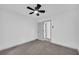 Bedroom with neutral carpet, ceiling fan, and an open door to the bathroom at 5200 Beechwood Forest Ct, Lithonia, GA 30038