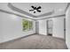 Bedroom featuring gray carpet, gray trim, recessed lighting, ceiling fan, window and doors at 5200 Beechwood Forest Ct, Lithonia, GA 30038