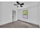 Bedroom with neutral carpet, ceiling fan, and a window view of the woods at 5200 Beechwood Forest Ct, Lithonia, GA 30038