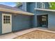 Exterior features a back door and walkway to covered outdoor area at 5200 Beechwood Forest Ct, Lithonia, GA 30038