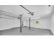 Spacious garage with neutral paint, epoxy floors, and entrance to the backyard at 5200 Beechwood Forest Ct, Lithonia, GA 30038