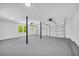 Spacious garage with neutral paint, epoxy floors, and window to the backyard at 5200 Beechwood Forest Ct, Lithonia, GA 30038