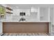 The kitchen features a quartz countertop island with wood accents, and updated appliances at 5200 Beechwood Forest Ct, Lithonia, GA 30038