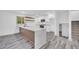 Open kitchen featuring an island with gray toned hardwood style floors at 5200 Beechwood Forest Ct, Lithonia, GA 30038