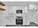 Modern white kitchen boasts stainless steel appliances at 5200 Beechwood Forest Ct, Lithonia, GA 30038