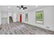 Bright, open living room with modern gray wood flooring and recessed lighting with stairs leading to the upper floor at 5200 Beechwood Forest Ct, Lithonia, GA 30038