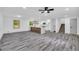 Bright living room features gray wood flooring, recessed lighting, and access to the updated kitchen and staircase at 5200 Beechwood Forest Ct, Lithonia, GA 30038