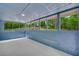 Enclosed sunroom with painted brick detail and large windows showcasing the wooded lot at 5200 Beechwood Forest Ct, Lithonia, GA 30038