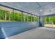 The enclosed sunroom features painted brick, screened windows, and access door at 5200 Beechwood Forest Ct, Lithonia, GA 30038