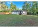 Lush, well-maintained backyard with a home exterior, spacious grassy area, and a newly installed wooden fence at 54 Mildred Ct, Dallas, GA 30157